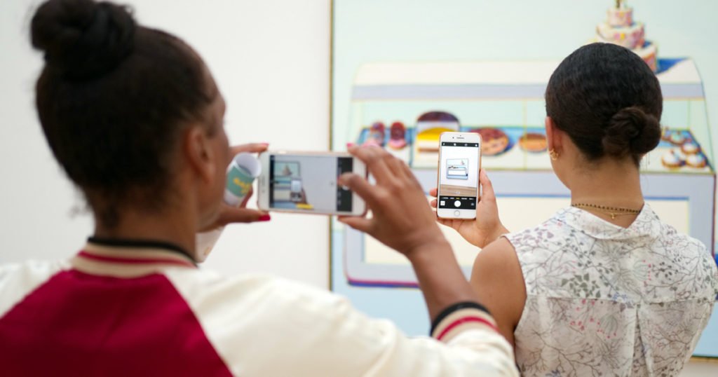 woman taking pic of another womans pic